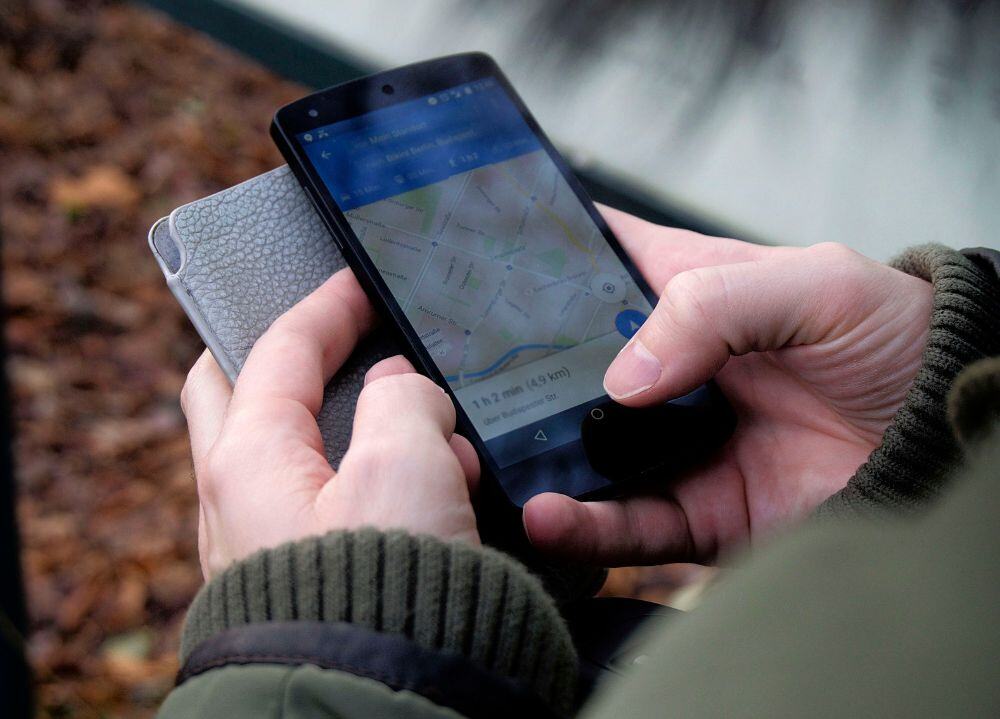 Guy holding phone with map pulled up